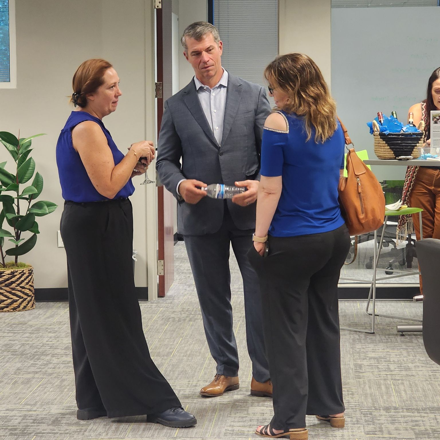 Three people talk during an event