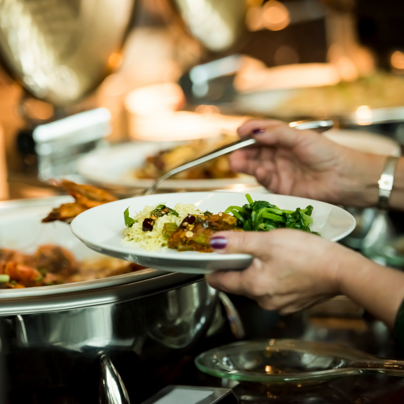 A woman serves herself at a lunch and learn